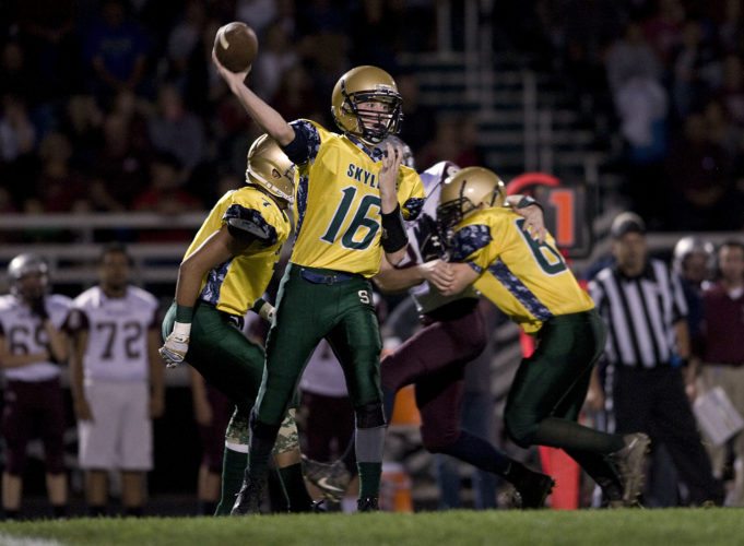 Skyline quarterback Dylan Hamman fires a pass during last week's game against Warren County. The Hawks host Culpeper tonight in a first-round playoff game. Rich Cooley/Daily file
